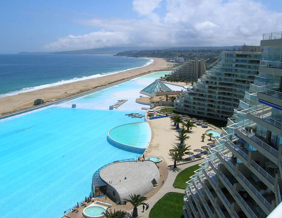 10 enticing pools that you wanna jump into,hanging gardens ubud hotel,neptune pool at the hearst castle in san simeon,california,the library pool in koh samui,thailand,cambrian pool,switzerland,bali,bali,infinity pool,singapore,st. regis in lhasa,tibet,chongwe river house pool,africa,belmond jimbaran puri resort,the san alfonso del mar seawater pool,chile,golden nugget pool in las vegas,nevada