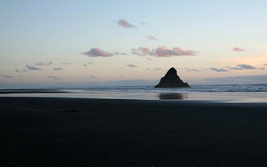 beautiful black sand beaches,black sand beaches,black sand beaches in the world,vik beach,iceland,perissa beach,greece,playa jardín,canary islands,karekare beach,new zealand,stokksnes beach,iceland