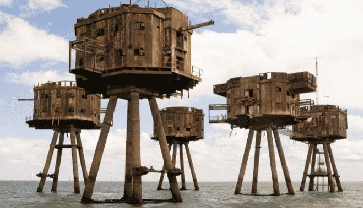 ghost places around the world,abandoned places tourism,kolmanskop namibia ghost town,craco italy abandoned town,hashima island gunkanjima japan,beelitz sanatorium germany abandoned,maunsell forts england history,deserted places attractions,urban exploration destinations,forgotten landmarks tourism