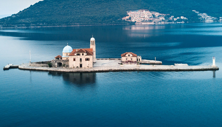 wonder buildings built on water,burj al arab,our lady of the rocks,veluwemeer aqueduct,venetian islands,punta della dogana,jal mahal,pampus,peberholm,deeg water palace,kansai airport,ile aux cygnes,travel,travel tips,holidays,travel guide