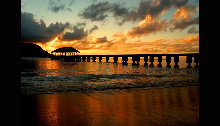 sunset around the world,beautiful sunset,the serengeti,tanzania,hanalei bay,hawaii,santa monica pier,los angeles,taj mahal,india