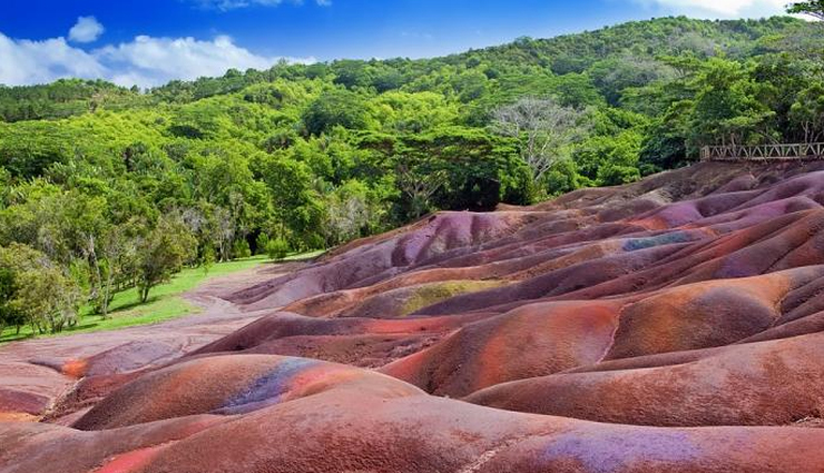 unique places to visit in the world,spotted lake of osoyoos,british columbia canada,chamarel falls and the colored earth,mauritius,rio tinto,spain,fly geyser reno,nevada,vale da lua,brazil,cano cristales,colombia