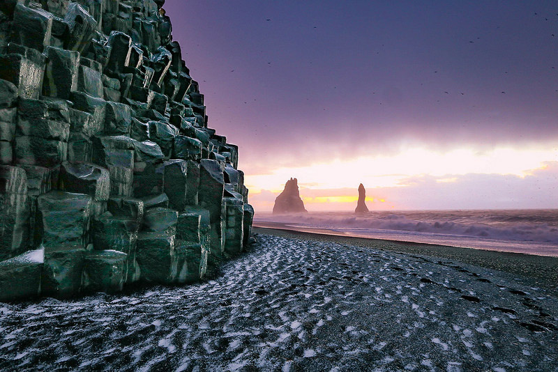 beautiful black sand beaches,black sand beaches,black sand beaches in the world,vik beach,iceland,perissa beach,greece,playa jardín,canary islands,karekare beach,new zealand,stokksnes beach,iceland