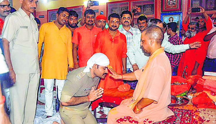 Officer in uniform kneels before Yogi